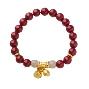 Bracelet en perles de cinabre rouge avec breloques lotus dorées et perles de jade
