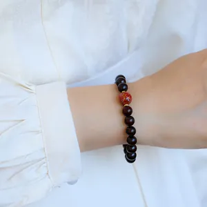 Natural red lacquer and dark sandalwood beaded bracelet with gold cloud patterns
