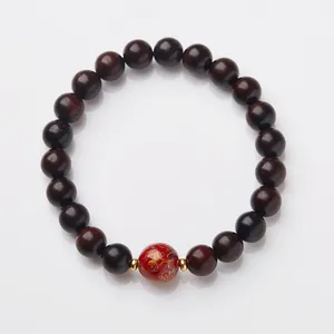 Natural sandalwood prayer beads with red enamel centerpiece and golden cloud patterns