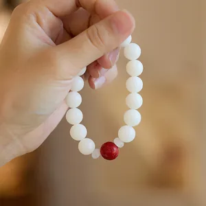 White jade bodhi seed bracelet with a red cinnabar bead and Chinese lucky symbols