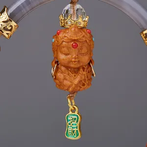 Macro detail of sandalwood Buddhist car pendant with golden crown and lucky charm