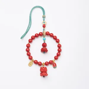 Traditional cinnabar red car pendant with dragon motif and lotus flower ornament