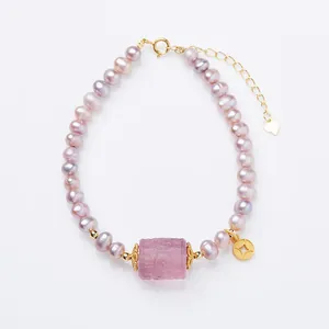 Elegant purple freshwater pearl bracelet with pink carved bead and gold heart charm