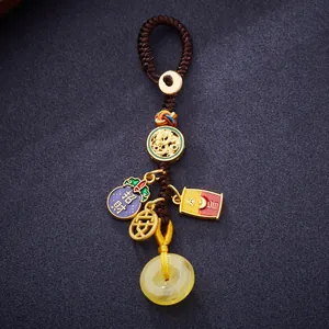 Chinese fortune keychain with amber donut, gold dragon disk, and enamel charms