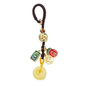 Traditional Chinese braided keychain with golden dragon charms and amber-colored donut jade