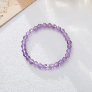 Macro shot of natural translucent purple amethyst beaded bracelet with silver spacer bead
