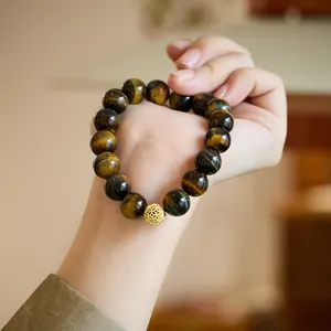 Natural tiger eye stone bead bracelet with a golden hollow charm ball for women