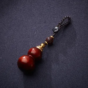 Red sandalwood gourd keychain with lid, carved lotus charm and black braided cord