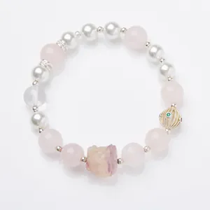 Natural pink crystal and fluorite beaded bracelet with lion pendant and pearl accents
