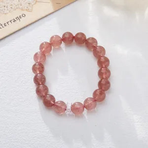 Macro detail of natural pink strawberry crystal beads with a sparkling silver accent