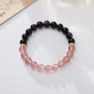 Natural strawberry crystal and obsidian beaded bracelet with gold pavé spacers on white base