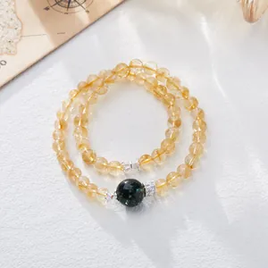 Double-layer citrine beaded bracelet featuring a dark green bead and silver accents