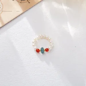 Detail of freshwater pearl ring with blue jade and red beads in vintage ethnic style
