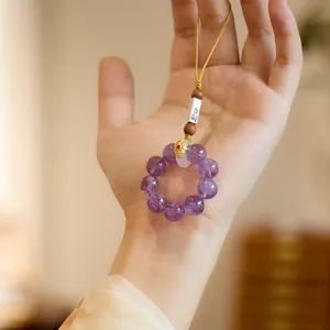 Handmade amethyst crystal phone strap with purple round beads and yellow woven cord