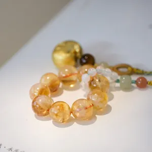 Natural yellow citrine beaded bracelet with golden bell charm and braided rope