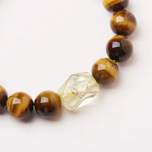 Natural 10mm tiger eye stone bracelet with faceted citrine crystal on white background