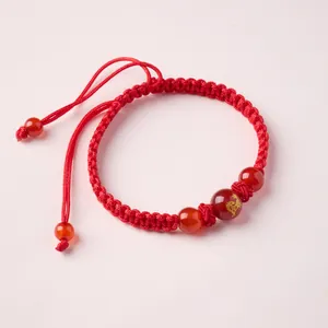 Red braided rope bracelet with red agate beads and golden dragon motif for good luck