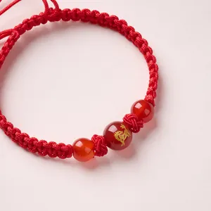 Handmade red string bracelet with natural agate beads and gold dragon pattern