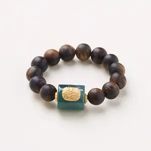 Wild agarwood 4mm beaded ring with green jadeite centerpiece and gold carved inlay