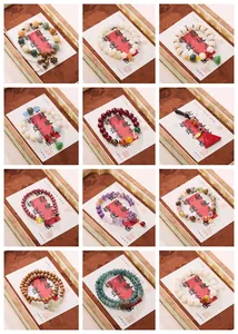 Detailed grid of twelve varied Chinese style beaded bracelets with lotus charms