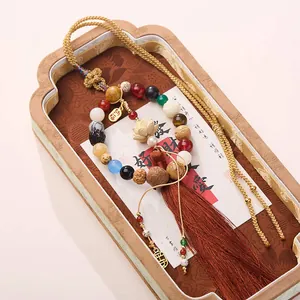 Traditional Chinese Buddhist prayer beads with carved lotus flower and silk tassel