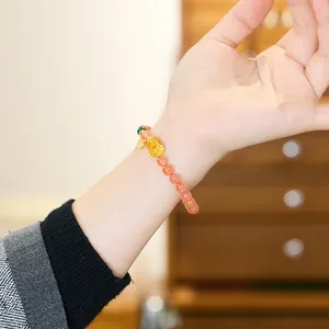 Natural Southern Red Agate beaded bracelet with golden Pixiu and jade accents on wrist