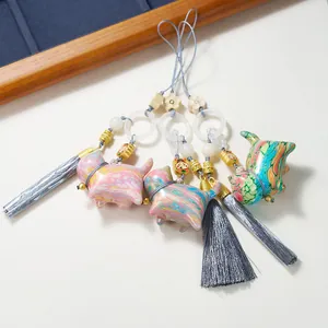 Three cat-shaped sandalwood pendants with colorful marble texture and matching silk tassels