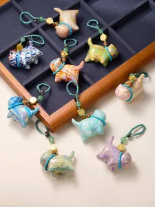 Detail of colorful marble-textured cat charms with braided ropes and Fu metal beads