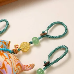 Chinese lacquer cat keychain with green woven rope and gold Fu lucky pendant