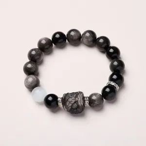 Bracelet en perles d'obsidienne et pierre de lune avec un charme lion sculpté