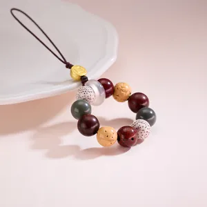 Close-up of Bodhi beads and wood beads keychain with a golden coin metal charm