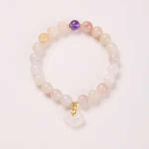 Close-up of natural stone bracelet with purple bead and white cloud pendant decoration