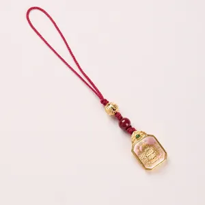 Traditional Zaki Lhamo Thangka pendant with red woven cord and gold deity charm