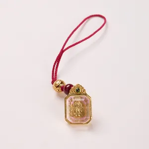 Octagonal Zaki Lhamo Thangka pendant with golden deity relief and pink resin