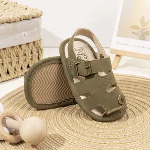 Close-up of olive green baby sandals with bronze buckle and soft non-slip sole details