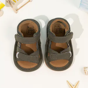 Detail view of baby camo sandals showing the 0-6 months size marking and velcro straps