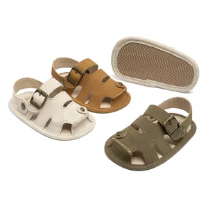 Detail view of baby walking sandals showing non-slip wavy soles in cream, tan and olive