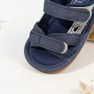 Detailed close-up of navy camo baby sandals with soft non-slip sole and Velcro strap