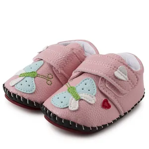 Detail of pink baby walking shoes with butterfly applique and velcro closure