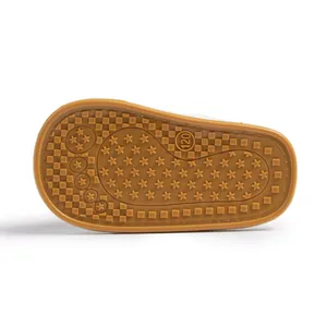 Detailed view of non-slip rubber baby shoe sole with star patterns and size 120 mark