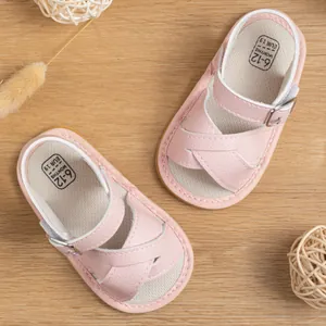 Pink cross-strap baby sandals with soft rubber soles for 6-12 months infants