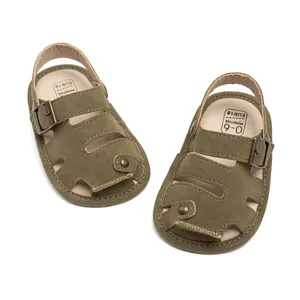 Close-up of olive green baby sandals featuring closed-toe hollow design and size EUR 18