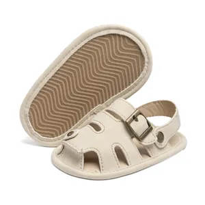 Detail view of baby closed-toe sandals with non-slip wavy soles and buckle strap