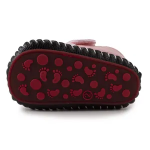 Detail of baby shoe rubber sole with non-slip footprint patterns and size 2 mark