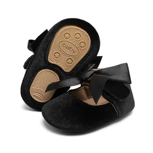 Detail of baby Mary Jane shoes with velvet fabric, satin bow, and anti-slip rubber sole