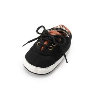 Detail of baby canvas shoes with soft sole and classic plaid interior lining