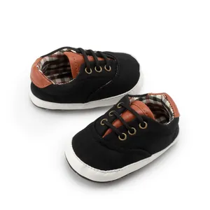 Detail view of baby canvas shoes with plaid lining and soft anti-slip soles