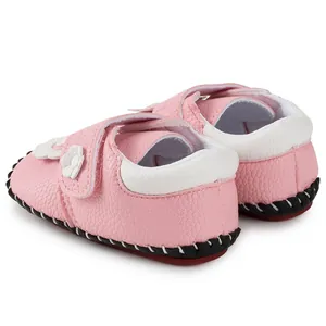 Rear view of pink baby walking shoes with white flower detail and Velcro closure