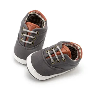 Detail view of baby canvas walking shoes with soft soles and brown checkered lining