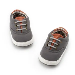 Detail view of baby canvas shoes with soft rubber sole and classic plaid lining fabric